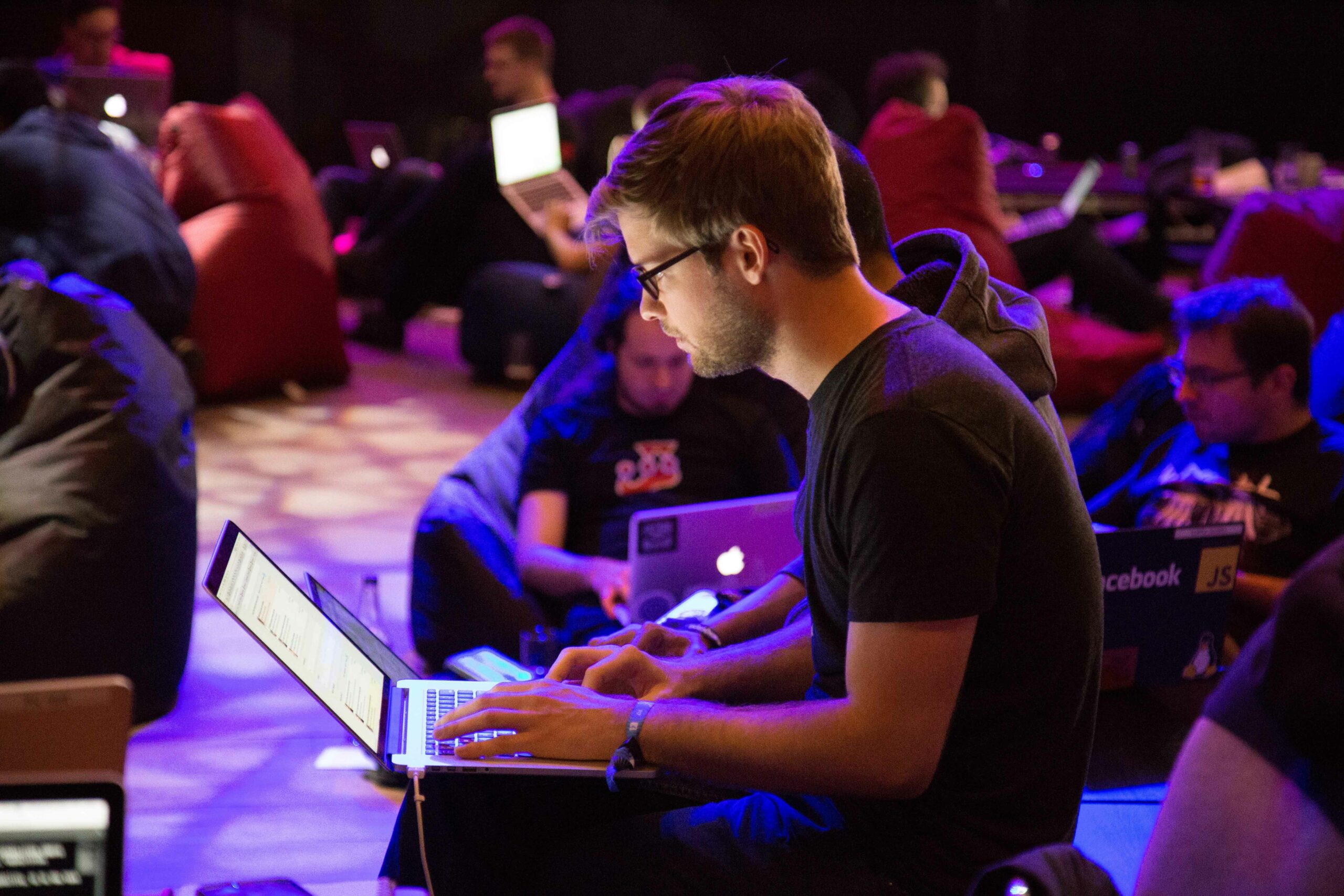 stock image of young man working on a computer at a conference