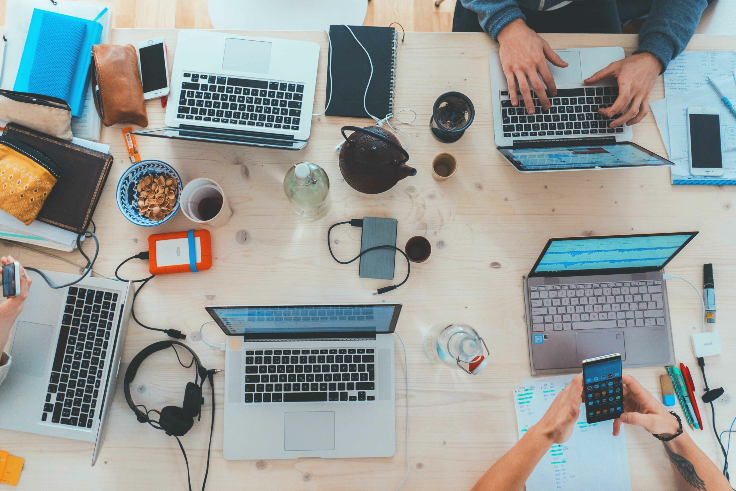 stock image of hands working at laptops