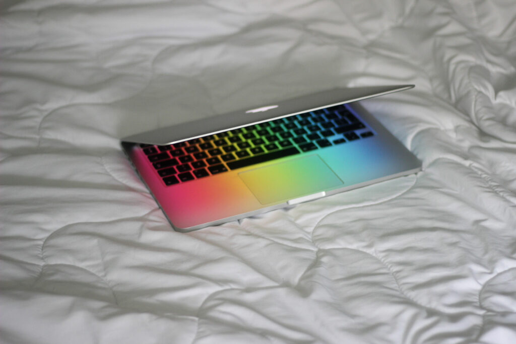 photo of a laptop with raindbow illumination