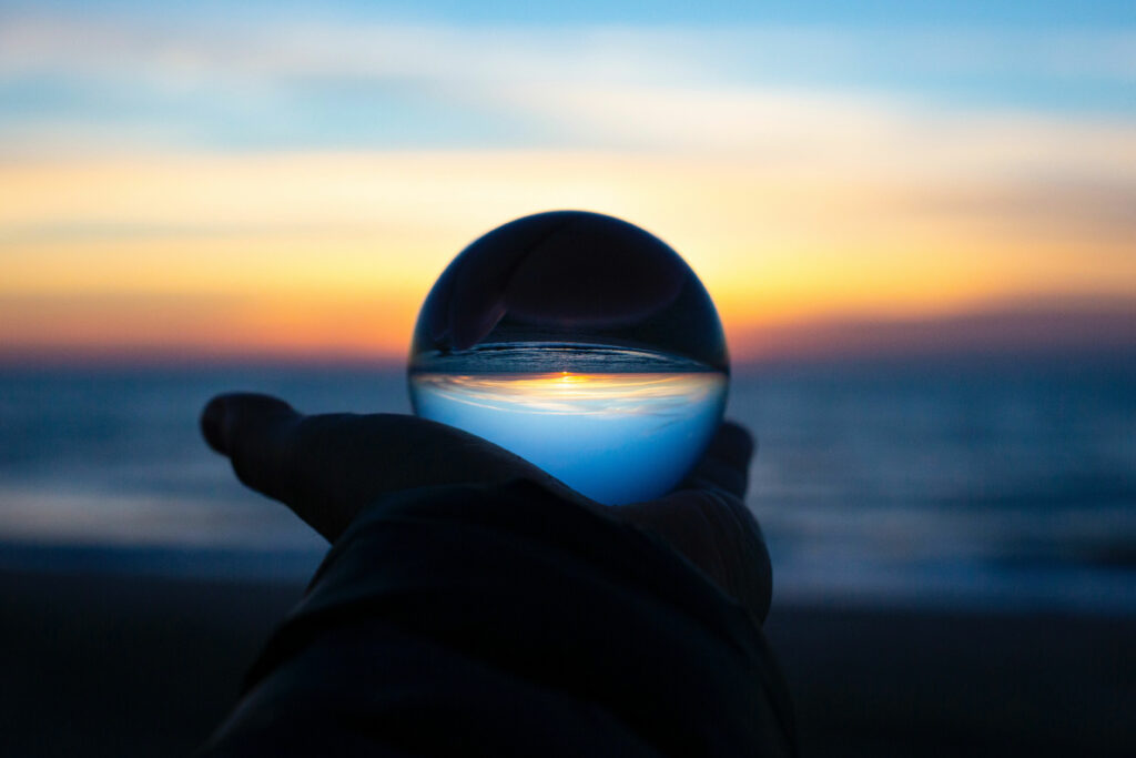 image of a crystal ball in front of a sunset